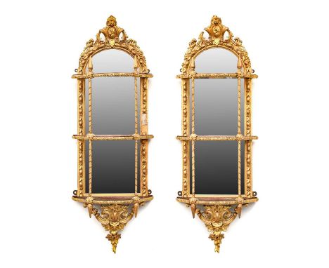 {} A Pair of Early Victorian Gilt and Gesso Wall Brackets, circa 1840, with arched mirror plates within an acanthus and beade