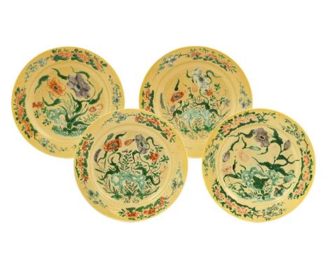 ^  A Set of Four Chinese Porcelain Plates, Kangxi, painted in famille verte enamels with foliage and rockwork on a cafe-au-la