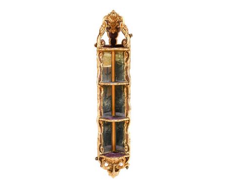 ~  A Victorian Gilt and Gesso Mirrored Corner Shelf, circa 1870, with scrolled and acanthus decorated frame supporting four s