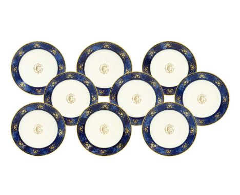 ^  A Set of Nine Sèvres Porcelain Plates, circa 1870, gilt with a monogram within a mottled blue border gilt with foliage and