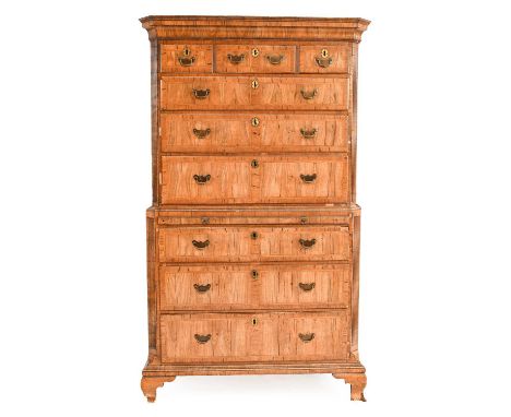 ~ A George I Walnut and Feather-Banded Chest on Chest, circa 1720, the moulded cornice above three short and three long oak-l