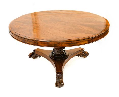 A William IV Rosewood Circular Dining Table, 2nd quarter 19th century, the moulded and crossbanded edge above a plain frieze,