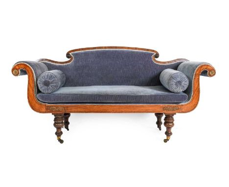 ~  A Regency Mahogany, Ebony Strung and Gilt Metal Mounted Scroll End Sofa, early 19th century, recovered in blue velvet, wit