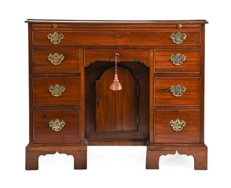 A George III Mahogany, Rosewood Crossbanded and Boxwood Strung Kneehole Dressing Table, circa 1780, the moulded top above a p