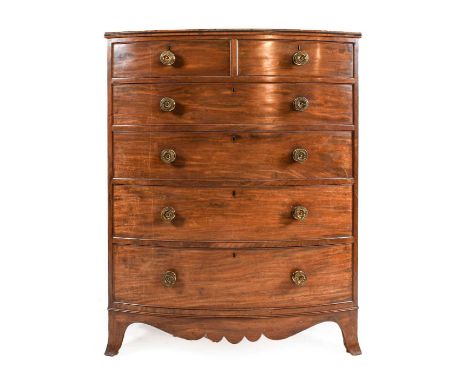 ~  A Regency Mahogany Bowfront Chest of Drawers, early 19th century, the moulded top with ebony banding above two short and f