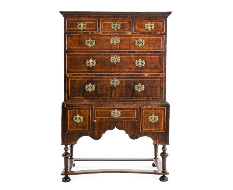 A George I Walnut and Boxwood Strung Straight Front Chest on Stand, 2nd quarter 18th century, the moulded top above three fri