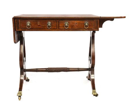 ^  A Regency Mahogany and Ebony-Strung Sofa Table, early 19th century, with two real and two sham oak-lined drawers with lion