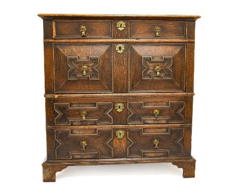 A Late 17th Century Oak Chest of Drawers in two parts, the moulded top above an arrangement of four geometric moulded drawers