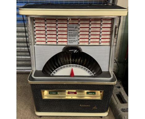 An Eltec F100 jukebox with records (Sold as seen, untested)