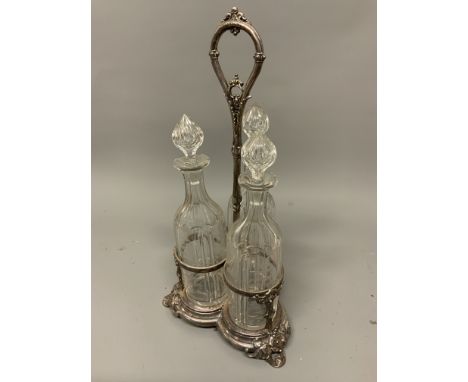 A silver plated three bottle table top decanter set. H:46cm