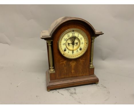 An American Ansonia mahogany cased mantel clock, with Arabic ivory coloured enamel chapter ring, beetle and poker hands and t