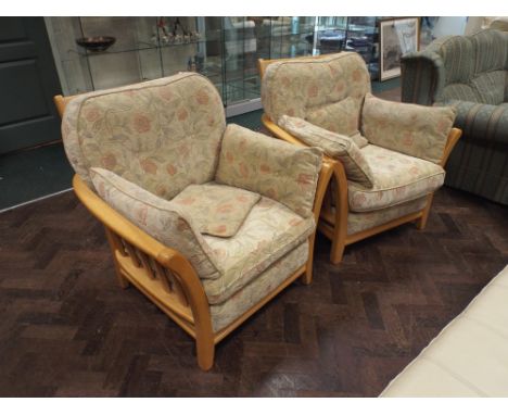 pair of light oak framed modern easy chairs in fawn floral covers