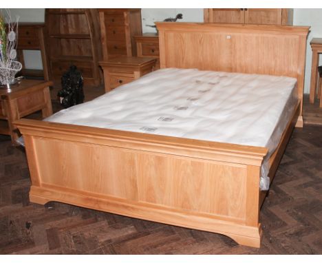 5' kingsize light oak bedstead with panelled head and foot boards together with a good quality pocket sprung mattress 