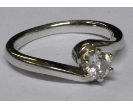 An 18ct white gold diamond solitaire ring in clawed crossover setting, approx 3.6g.