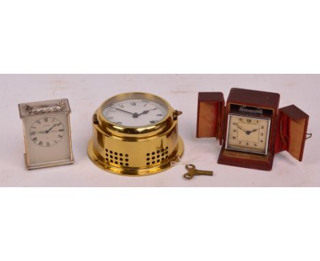 A vintage chrome alarm clock, the rectangular dial set with Arabic numerals, cased, a further alarm clock in the form of a ca