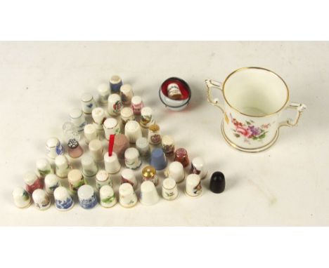 A collection of various ceramic thimbles including Royal Worcester, Spode, Limoges and Minton, also a glass millefleurs decor