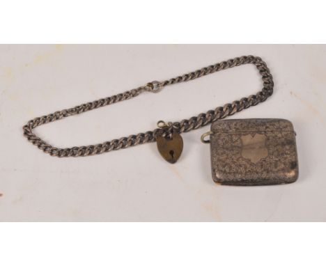 A Victorian hallmarked silver vesta case of rectangular form with overall engraved floral decoration, centred with a shield s
