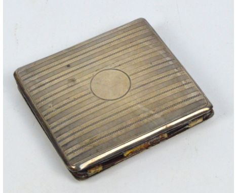 A George V hallmarked silver rectangular cigarette case with overall engine turned decoration, centred with circular vacant c