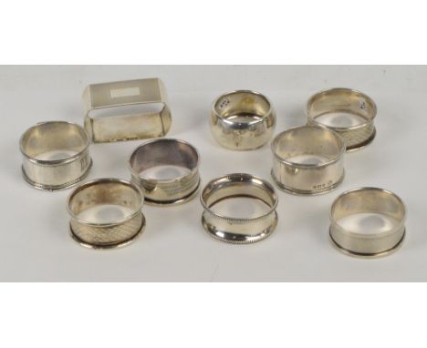 A collection of hallmarked silver napkin rings including a pair of George V examples with engine turning and initialled carto