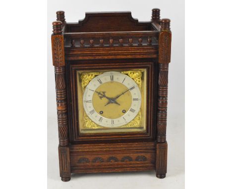 A c.1900 oak cased Winterhalder and Hofmeier mantel clock with pierced gallery, silvered chapter ring set with Roman numerals
