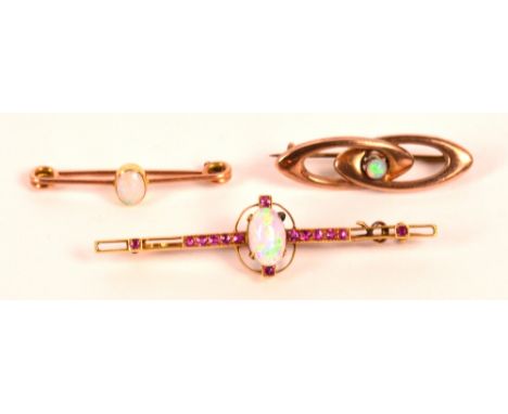 A 15ct yellow gold Art Deco style bar brooch set with a central oval opal with a line of small rubies, length 5.5cm, and a sm