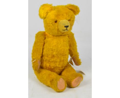 A c.1940s German teddy bear "Hermann", with rod joints, yellow plush fur, stitched nose and mouth, height 50cm.