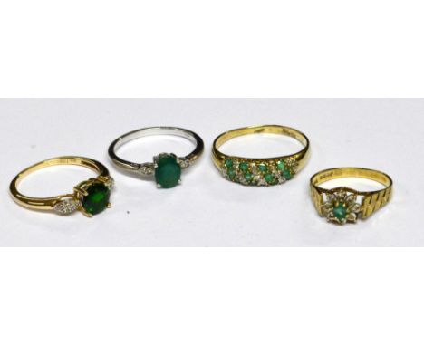 A collection of dress rings comprising a 9ct yellow gold ring with green stones interspersed by lines of diamond chips, size 