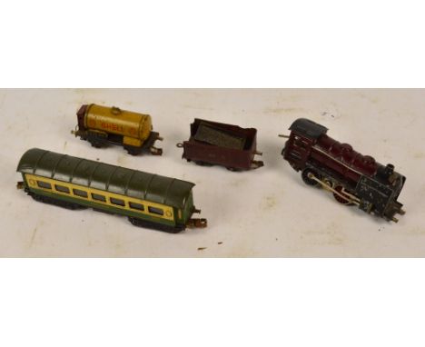 A small collection of playworn German model railway items comprising a diecast engine (one wheel af), a tin plate coal tender