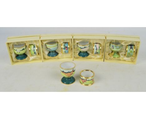 Five boxed Moorcroft enamel egg cup and napkin ring sets, decorated with pigs, sheep, chickens, mallard ducks and swallows, e