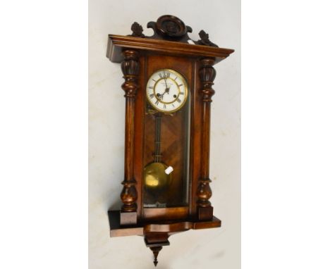 A late 19th century walnut and stained beech spring driven Vienna style wall clock, the circular enamel dial inscribed "Fatto