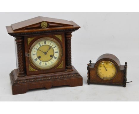 JUNGHANS; a c.1900 German oak cased striking mantel clock, the circular dial set with Roman numerals flanked with barley twis