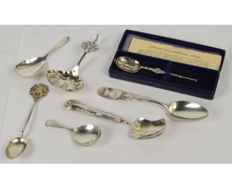 An interesting collection of silver spoons comprising a late Victorian plain caddy spoon, James Swann & Son, Birmingham 1900,