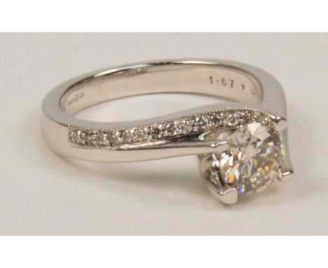 An 18ct white gold and diamond ring, the principal round brilliant cut stone weighing approximately 0.9cts with further diamo