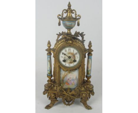 A 19th century French gilt metal porcelain mounted eight day mantel clock, the urn surmount above circular dial painted with 