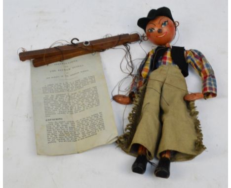A vintage Pelham string puppet of a cowboy, height 30cm, and an instruction sheet for Pelham puppets by Jan Bussell of the Ho