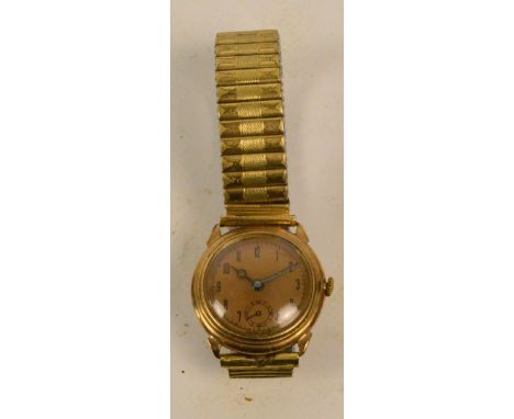 A gold cased manual wind gentleman's wristwatch, the circular dial set with Arabic numerals and with subsidiary seconds, on g