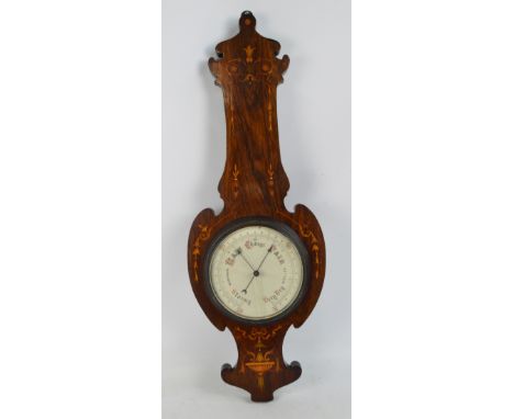 An Edwardian rosewood and satin inlaid barometer (for restoration), the circular dial within a floral decorated frame, length