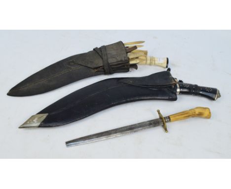 A Gurkha's kukri knife with bone handle, curved blade and set with numerous further small knives and accoutrements to a pouch