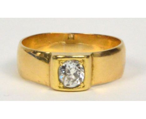 A gentleman's yellow metal single stone diamond ring, the slightly oval cut stone weighing approximately 0.6cts, in collet se