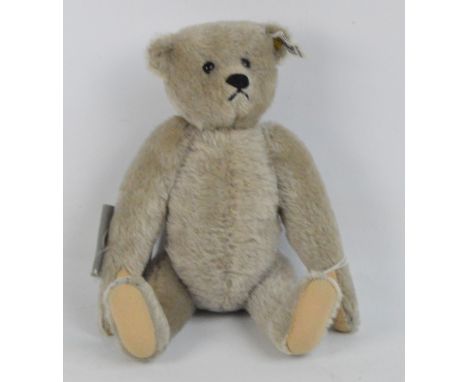 A boxed Steiff teddy bear, 1983 replica of 1902 Richard Steiff, no.0150/32, with white and black tag to ear, with short grey 