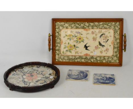 A Victorian ceramic tile based twin handled tray, 51 x 32cm, two Delft blue and white tiles showing farming and riverside sce