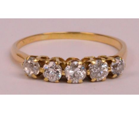 A yellow metal five stone diamond ring, each diamond weighing approximately 0.20cts, size R/S, approx 2.4g.