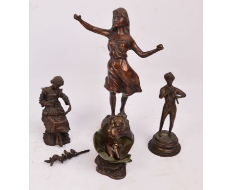 Four modern decorative figures including a girl on a lily pad, and boy playing a flute (4).