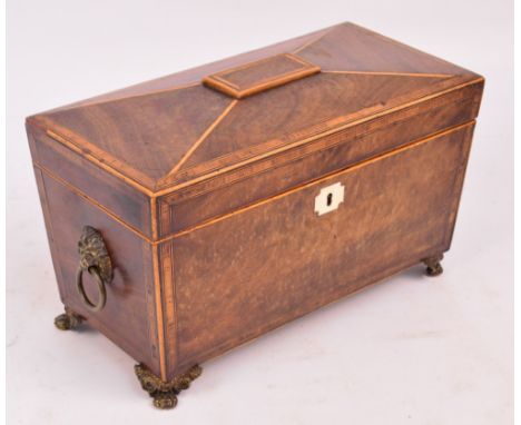 An early 19th century mahogany boxwood strung and crossbanded sarcophagus tea caddy, the hinged lid enclosing twin compartmen