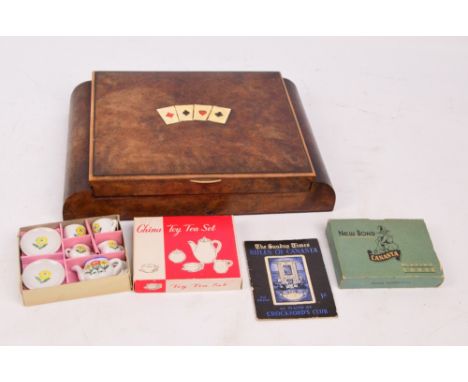 A burr walnut games box with hinged lid decorated with playing card suits, enclosing various plastic tokens, also a boxed chi