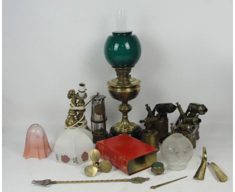 An oil lamp with brass reservoir and knopped stem, with funnel and white and green glass shade, a group of five blow lamps in
