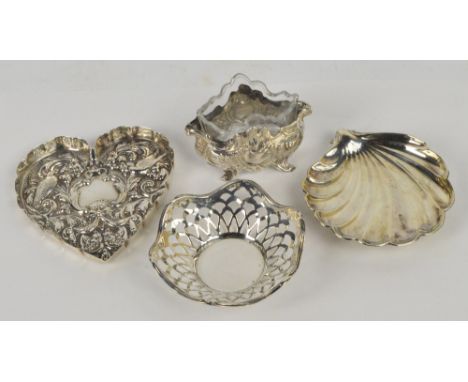 A Victorian hallmarked silver heart shaped trinket dish with repoussé decoration of birds and a scrolled mask, William Comyns