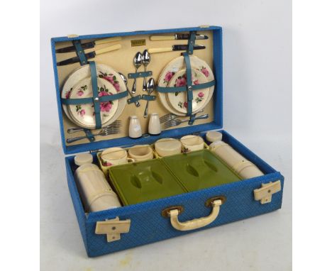 An early to mid 20th century Brexton picnic set with four setting comprising ceramic plates, cups and saucers, metal knives, 