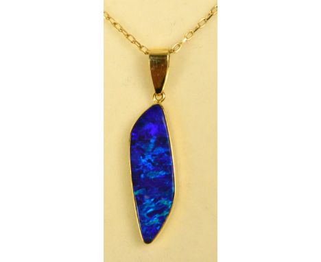 An 18ct yellow gold mounted black opal pendant of shaped rhombus form, hallmarked to the suspension ring, on 18ct gold fine o