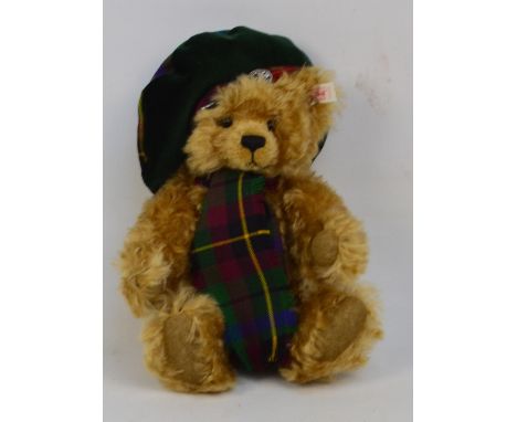 A boxed Steiff Scottish teddy bear no.654732, with numbered white and red tag to ear, with curly blonde mohair fur, with a sc